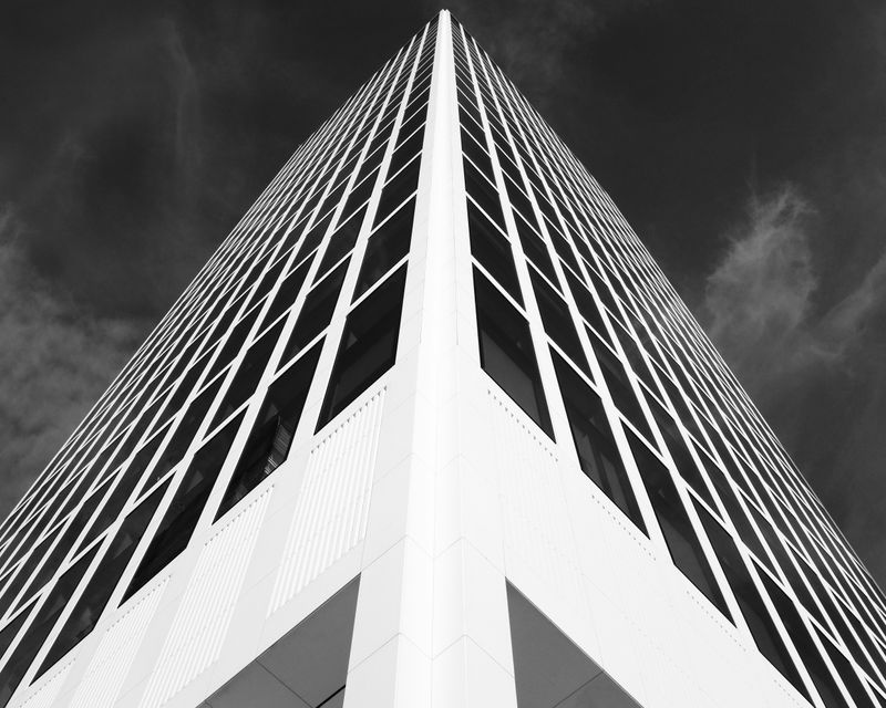 A tall building. The building's edge moves up the center of the image's frame.