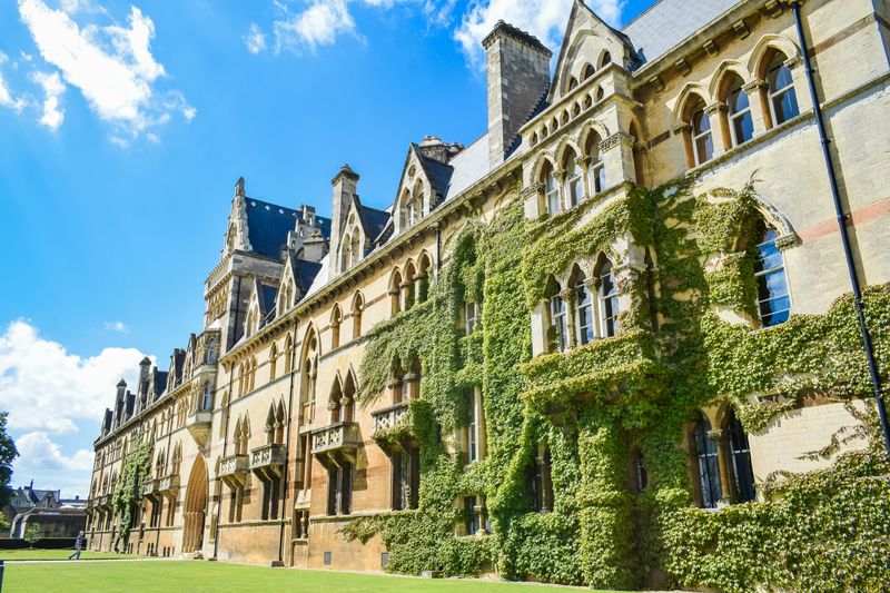 An old cathedral-style campus building covered in ivy.