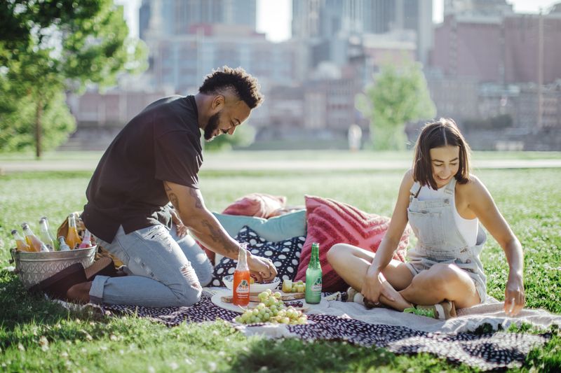 Two people are having a picnic outdoors