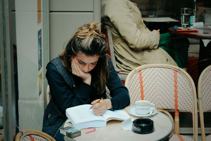 A woman studying at a cafe.