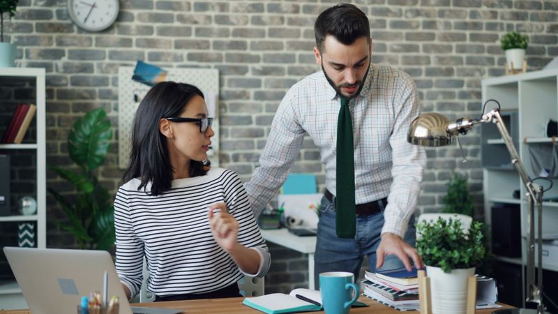 A man and a woman in an office.