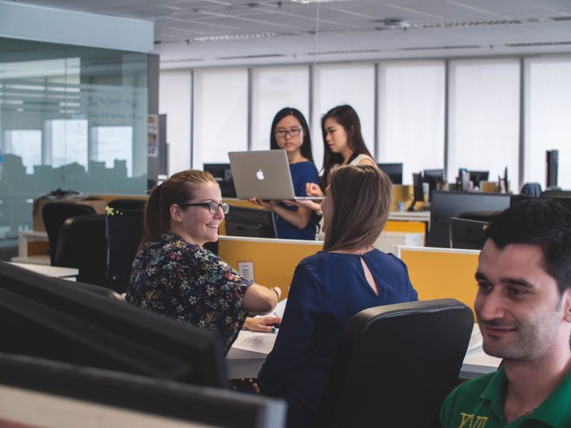 Individuals collaborating together in an office space.