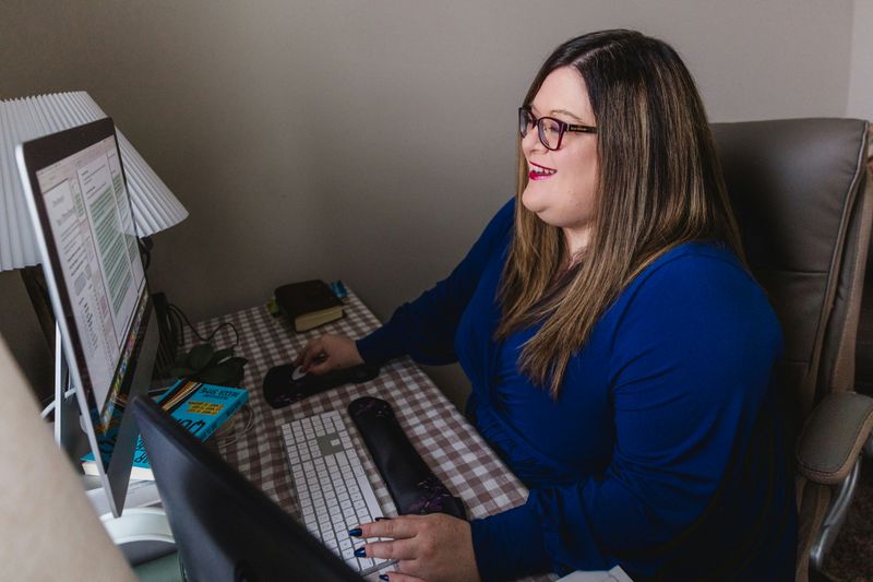 A teacher learning interesting examples for class by looking them up. on her laptop