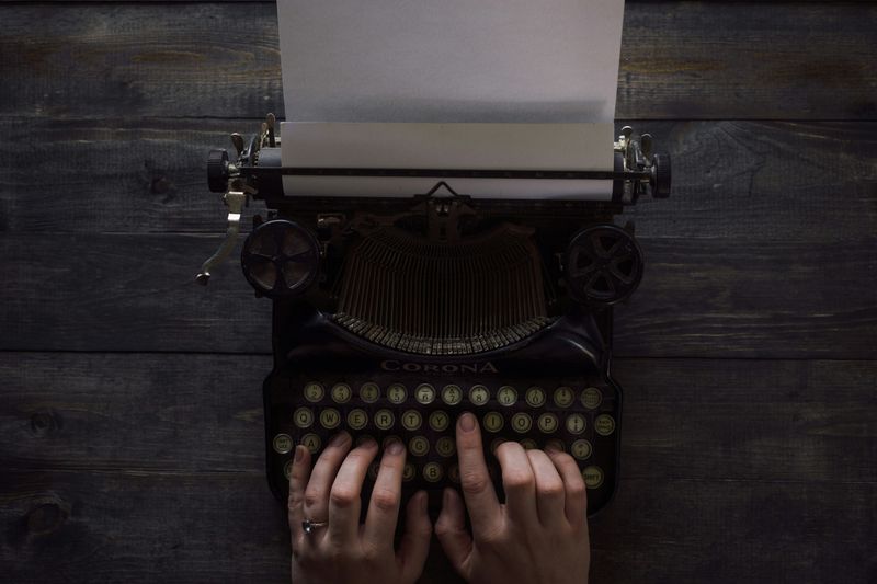 A person typing on a typewriter.