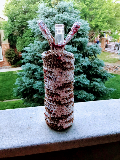 A wine bottle gift bag made with plarn.