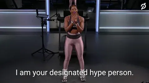 Fitness trainer mouthing the words, 'I am your designated hype person.'