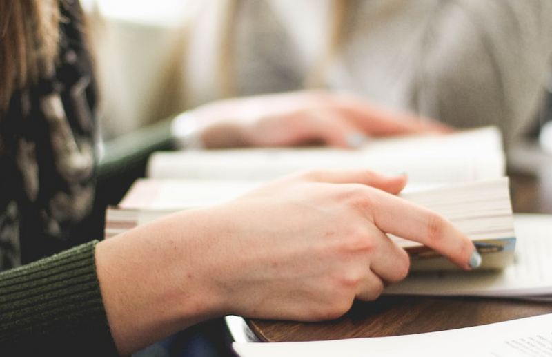 A person's hands opening a book.