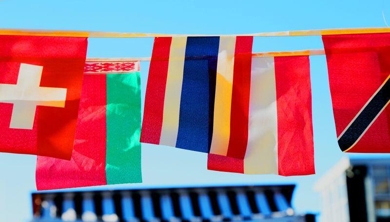 A series of flags hanging over a street.