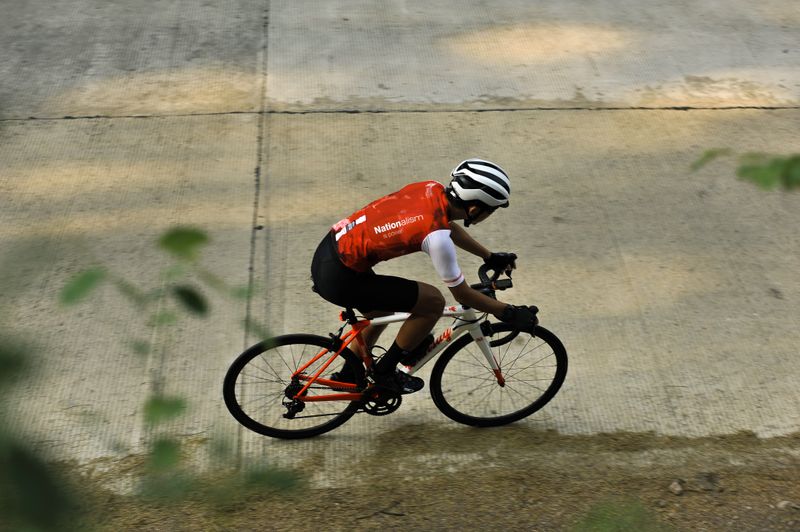 A person in spandex riding clothes on a road bike