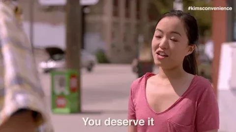 A woman on the street saying 'You deserve it'