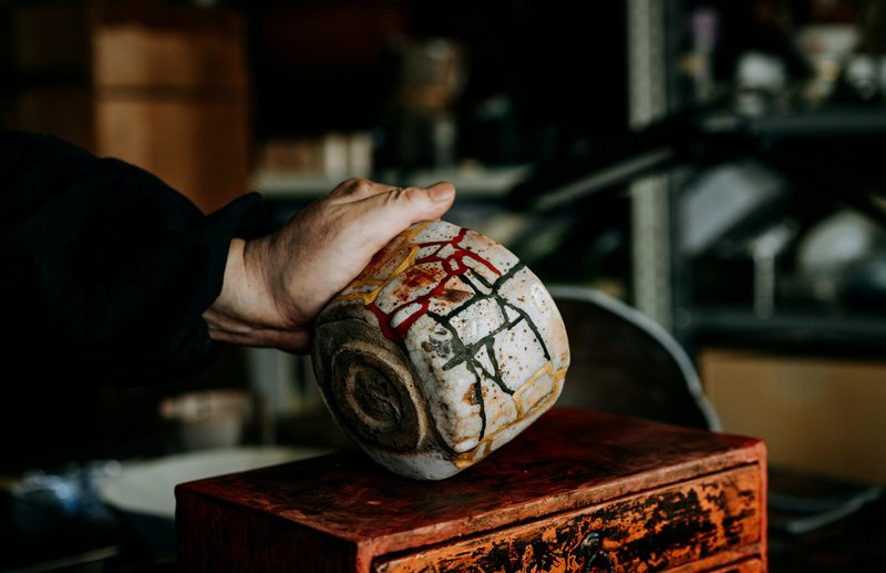 hand holding a kintsugi bowl 