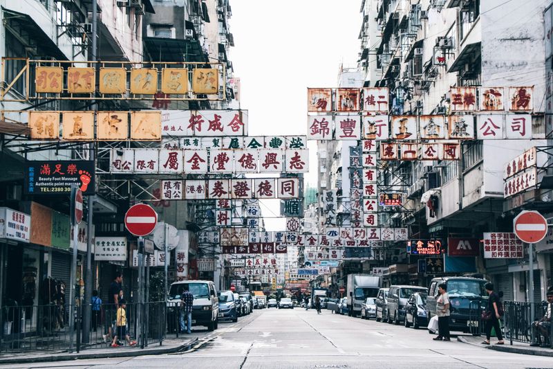 A Chinese city street with many old signs.