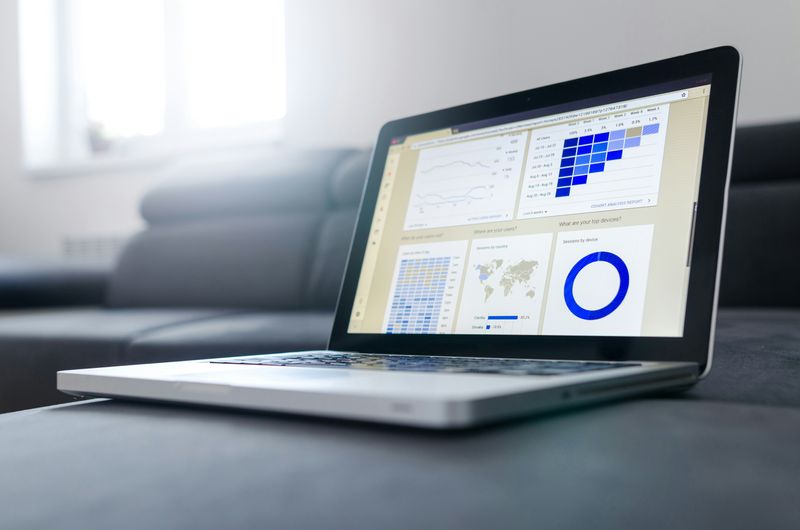 A laptop screen showing colorful graphs and charts, representing data analysis