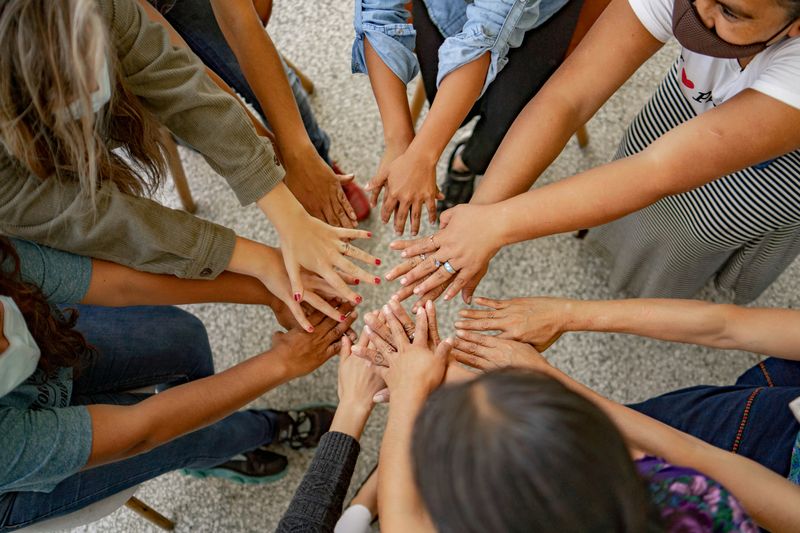 People are putting their hands together