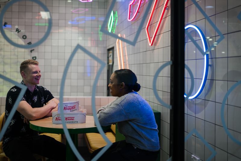 A man and a woman talking at table