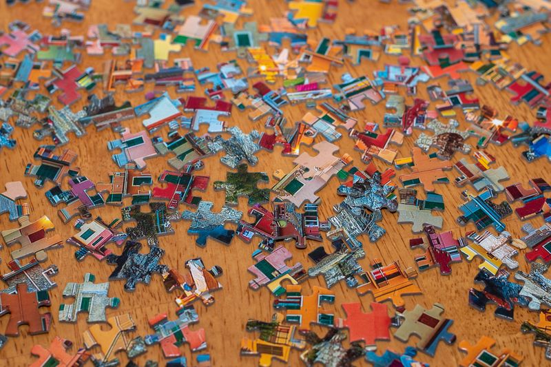 Jigsaw puzzle pieces scattered on a table