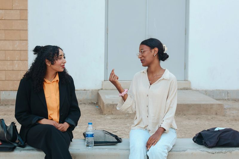 Two women in conversation. One is listening to the other. 