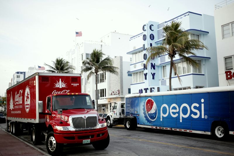 ACoca Cola and Pepsi tractor-trailers going in opposite directions.