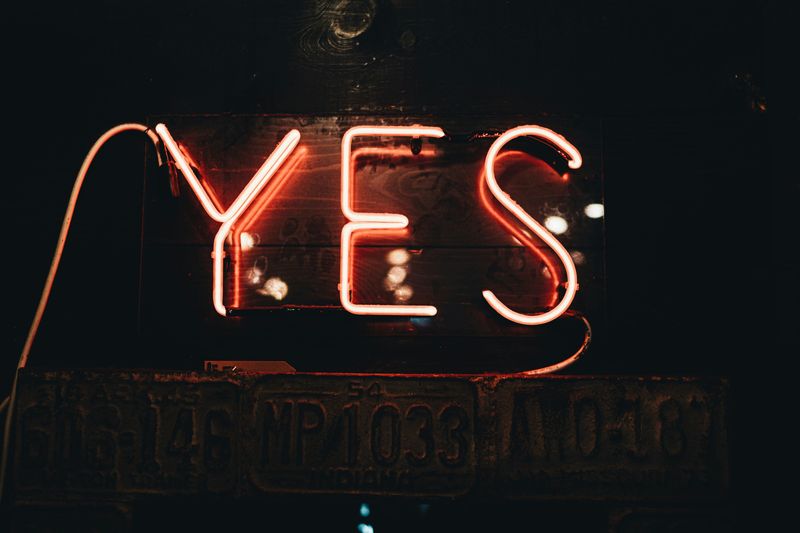 YES in red neon letters.