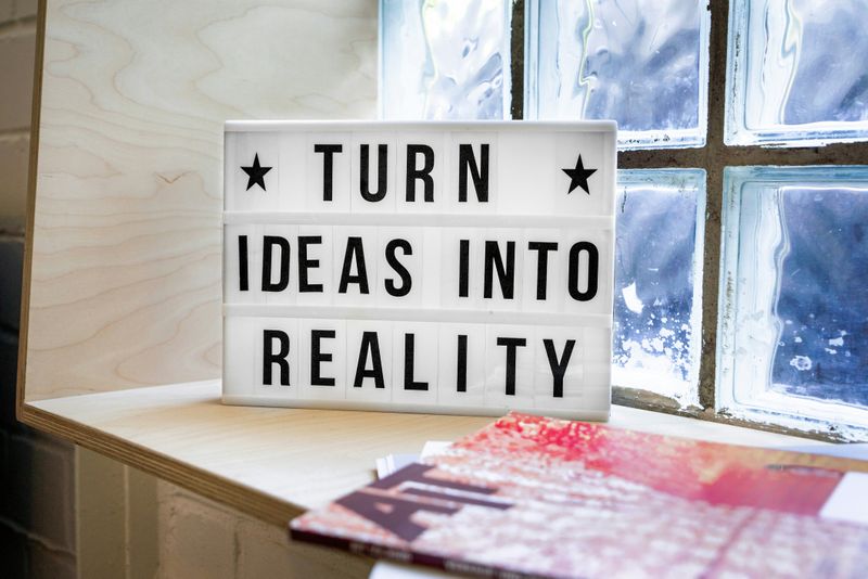 A sign on a window sill that reads, 'Turn ideas into reality'.