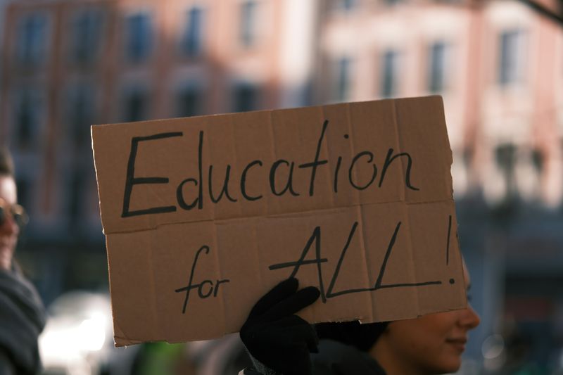 A cardboard sign that says, 