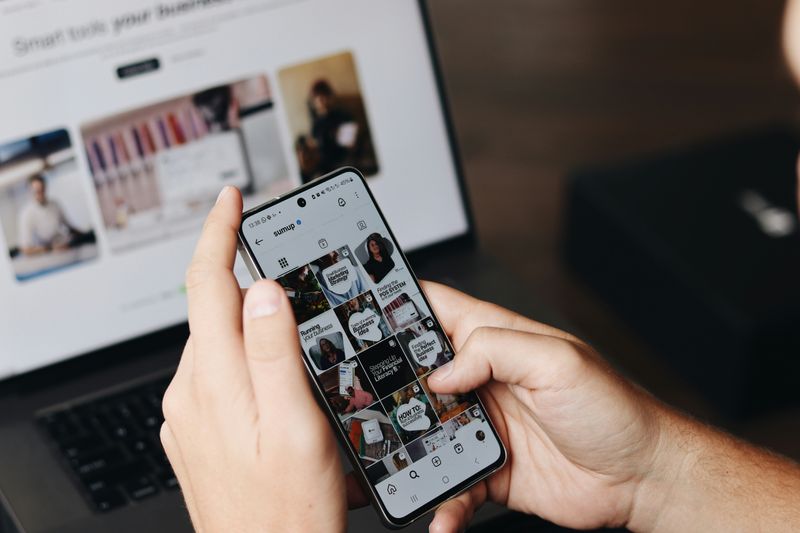 Close up of a phone screen opened on instagram with different type of posts