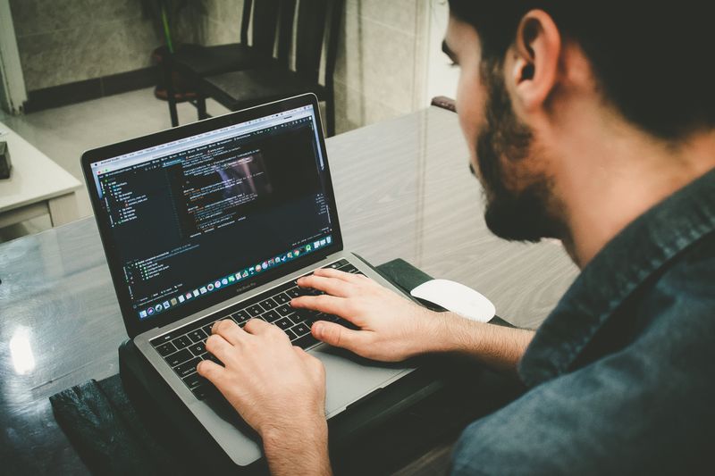 A programmer running code on a laptop.