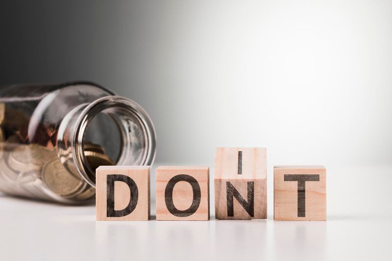 Image of a jar with coins with wooded blocks spelling D-O-N-T