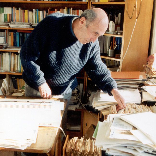 Niklas Luhmann, in his study, going through his notes from his Zettelkasten.