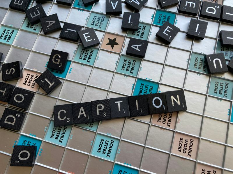 Scrabble letters spelling 'caption'.