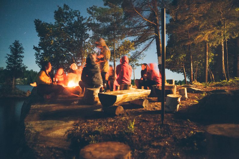 Image of people at a campfire gathering