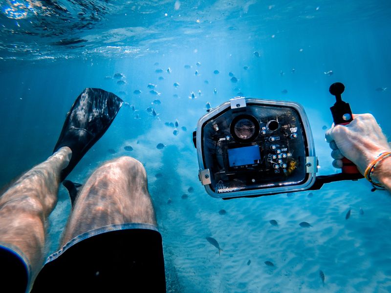 Person holding underwater technology tool