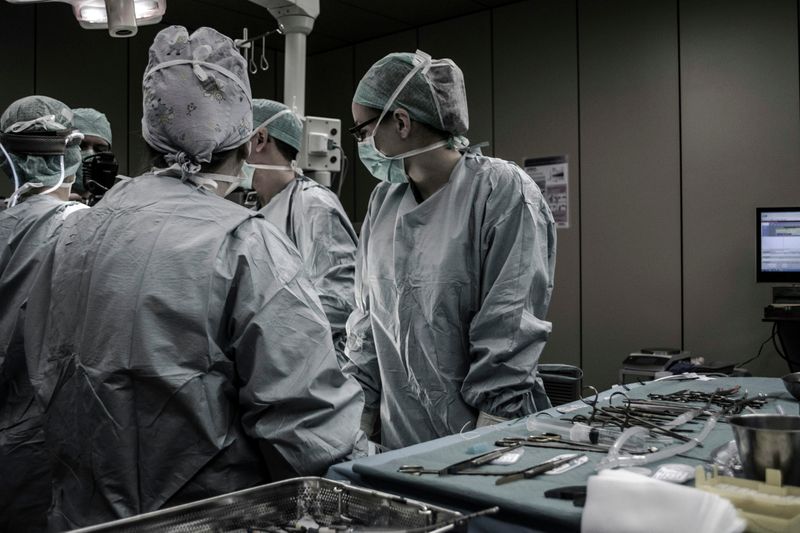 Healthcare workers on the job in an operating room.