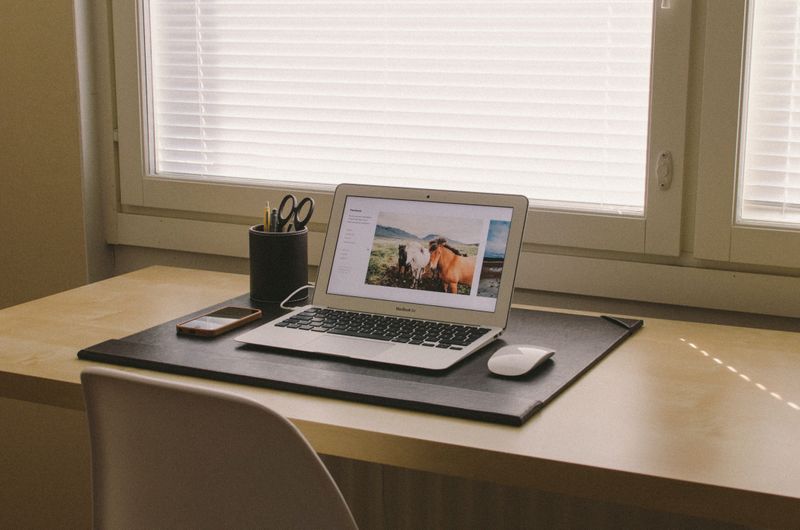 Clean desk with a laptop computer. Photo by Aleksi Tappura on Unsplash