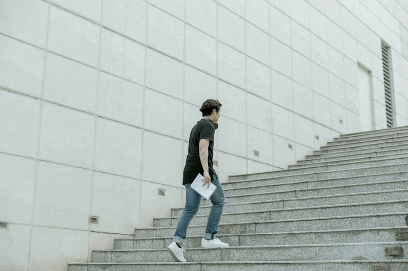 A man climbing up the stairs. 