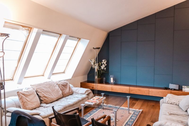 Attic apartment with large, angeled windows lproviding lots of sunlight.