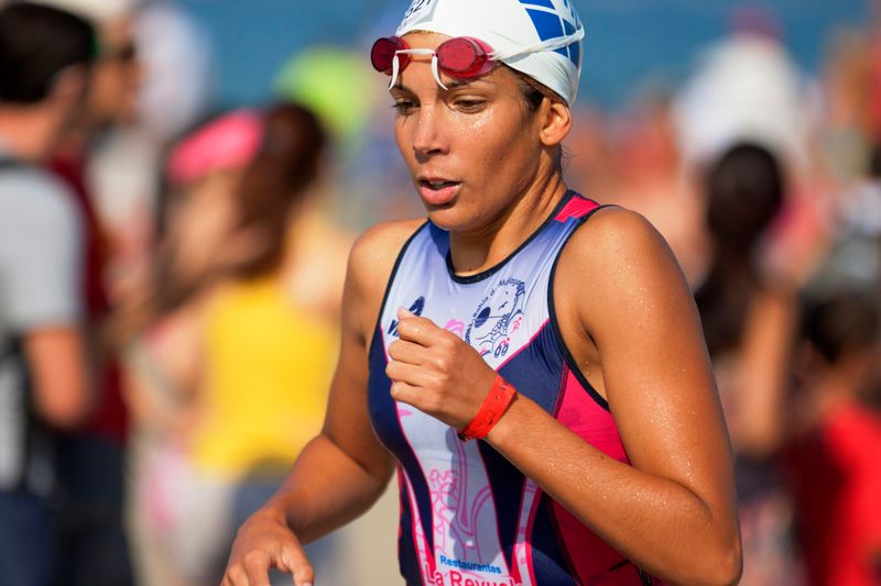 A swimming athlete out of the water deep in thought.