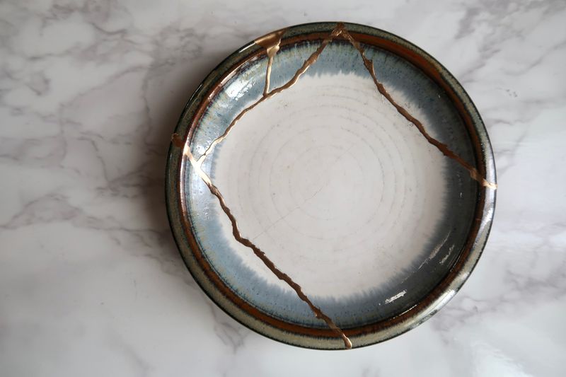 A bowl that has gold where it's cracks are.