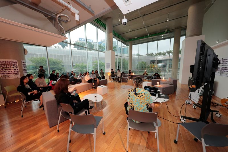 A group of students attending a seminar in a common area on campus.