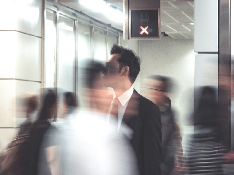 An office space with blurred outlines of people moving. 