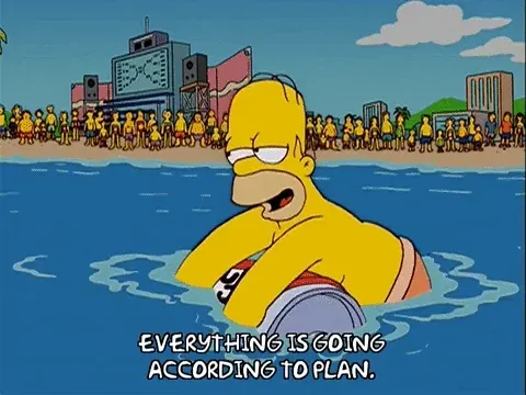 Homer Simpson floats in the ocean, smirking as he says, “Everything is going according to plan.”