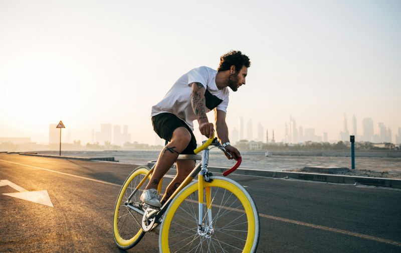 A young active man rides a bike.