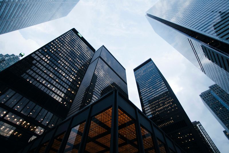 Looking up at the sky past skyscrapers. Corporate social responsibility.