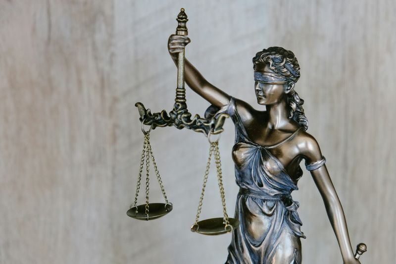 A statue of Lady Justice, holding scales and wearing a blindfold.
