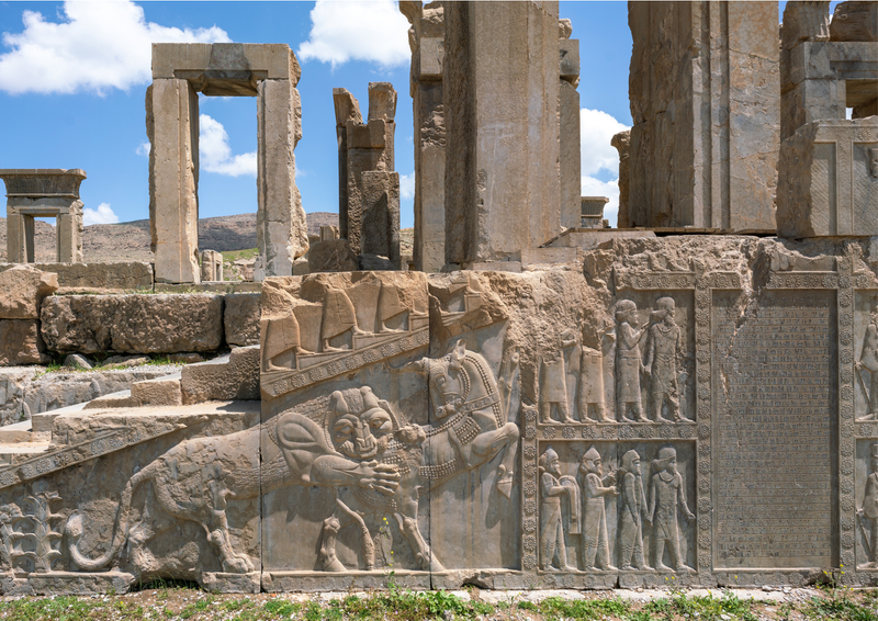 A panoramic view of Persepolis, the ancient capital of the Achaemenid Empire in Iran, with grand stone carvings.