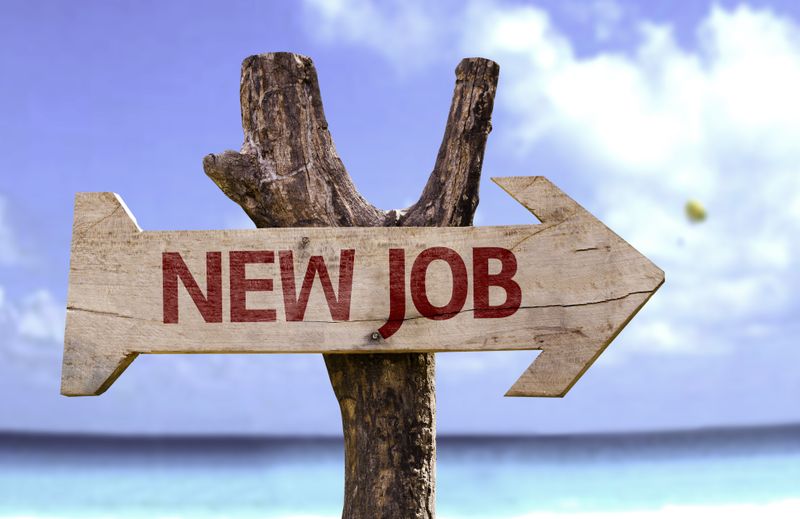 A wooden sign in shape of an arrow with text "New Job."