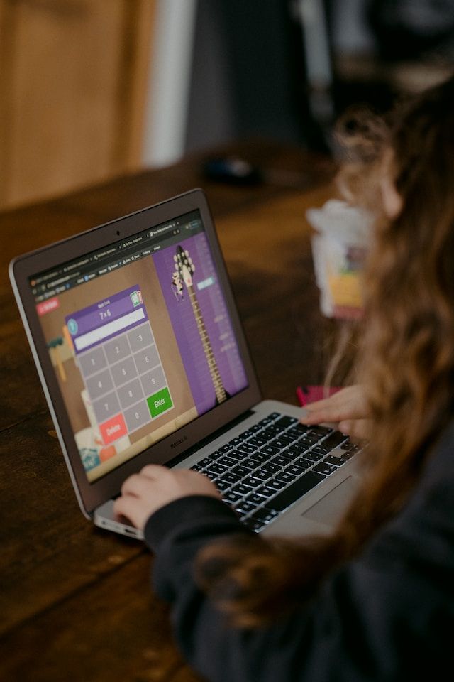 A child playing a multiplication game on a laptop.