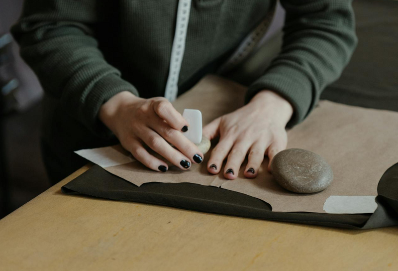 Person writing on a pattern with sewing chalk