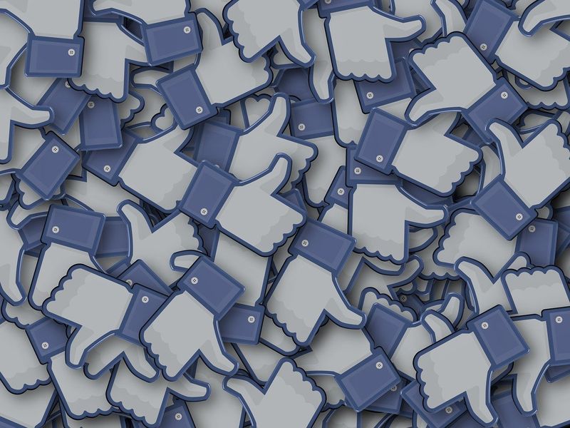 Facebook 'like' icons in a pile.