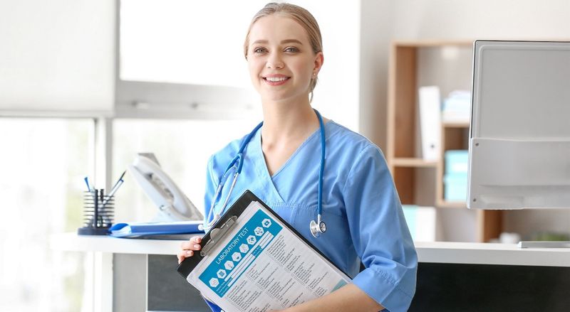 A medical assistant holding a chart.